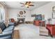 Cozy living room with fireplace, plush seating, and a ceiling fan at 6308 Walnut Grove Way, Erie, CO 80516