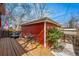 Charming backyard with a red-colored detached garage, patio area, and outdoor seating at 1346 Steele St, Denver, CO 80206