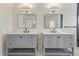 Modern bathroom featuring double vanity sinks with sleek black hardware and lighting fixtures at 1346 Steele St, Denver, CO 80206