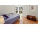 Bedroom with hardwood floors, natural light, and an ornate wooden chest at 1346 Steele St, Denver, CO 80206