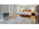 Bedroom with a wood bed frame, neutral bedding, a decorative rug, and a window for natural light at 1346 Steele St, Denver, CO 80206