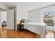 Cozy bedroom with hardwood floors, a black nightstand and white walls at 1346 Steele St, Denver, CO 80206