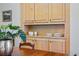 Dining area showcasing natural wood cabinetry with storage and a partially visible dining table with decorative plant at 1346 Steele St, Denver, CO 80206