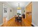 Charming dining room features hardwood floors, wooden table, and built-in wooden cabinets at 1346 Steele St, Denver, CO 80206