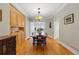 Charming dining room with natural wood floors, built-in cabinetry and a decorative pendant light fixture at 1346 Steele St, Denver, CO 80206