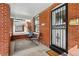 Charming front porch with seating area, brick facade and security door at 1346 Steele St, Denver, CO 80206