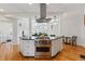 Spacious kitchen with large island, stainless steel oven and range, and view into the living room at 1346 Steele St, Denver, CO 80206