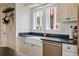 Bright kitchen featuring farmhouse sink, stainless appliances, and pot rack at 1346 Steele St, Denver, CO 80206