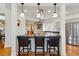 Eat-in kitchen featuring a center island with seating and pendant lighting at 1346 Steele St, Denver, CO 80206