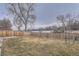 Spacious backyard with a wood fence, grass and lake views at 13158 W 62Nd Dr, Arvada, CO 80004