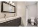 Modern bathroom featuring double vanity, large mirror, and shower/tub combination at 13158 W 62Nd Dr, Arvada, CO 80004