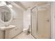 Simple bathroom with pedestal sink, toilet, and glass enclosed shower at 13158 W 62Nd Dr, Arvada, CO 80004