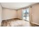 Neutral bedroom with wood floors, recessed lighting, and sliding glass doors to the backyard at 13158 W 62Nd Dr, Arvada, CO 80004