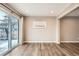 Bright dining room featuring wood floors, white ceiling, neutral walls, and sliding glass doors to the back at 13158 W 62Nd Dr, Arvada, CO 80004