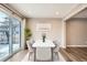 Elegant dining room with modern table, chairs, rug, wood floors, white ceiling, and sliding glass doors to the backyard at 13158 W 62Nd Dr, Arvada, CO 80004