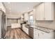 Spacious kitchen featuring granite countertops, stainless steel appliances, and white cabinetry at 13158 W 62Nd Dr, Arvada, CO 80004