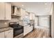 Modern kitchen with stainless steel appliances, granite countertops, white cabinets, and wood floors at 13158 W 62Nd Dr, Arvada, CO 80004