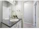 Bathroom featuring a large mirror, white cabinets, and granite countertops at 11524 Dewey St, Parker, CO 80138