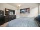 Bright bedroom with a large television, chandelier lighting, and comfortable carpet at 11524 Dewey St, Parker, CO 80138
