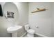 Clean and well-lit half bathroom with a modern vanity and decorative mirror, creating a functional space at 11524 Dewey St, Parker, CO 80138