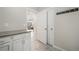 Hallway with white trim and access to open-concept living area at 11524 Dewey St, Parker, CO 80138