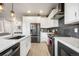 Modern kitchen with a spacious island, stainless steel appliances, and sleek black accents for a contemporary look at 11524 Dewey St, Parker, CO 80138
