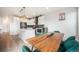 Bright kitchen features an island, stainless appliances, and a modern dining area with stylish, emerald green chairs at 11524 Dewey St, Parker, CO 80138