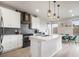 Modern kitchen with a spacious island, sleek white cabinets, stainless steel appliances, and a cozy dining area at 11524 Dewey St, Parker, CO 80138