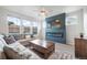 Cozy living room featuring a sleek electric fireplace, plush sofa, and bright natural light at 11524 Dewey St, Parker, CO 80138