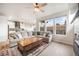 Spacious living area with a large sectional, wooden coffee table, and an open view to the kitchen at 11524 Dewey St, Parker, CO 80138