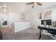 Carpeted loft area featuring a desk and view of another room at 11524 Dewey St, Parker, CO 80138