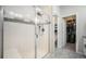 Modern shower with glass door, tile surround, and a view into an adjacent closet at 11524 Dewey St, Parker, CO 80138