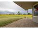 Outdoor patio featuring stone pavers and view of the grassy lawn at 46531 Sundance Trl, Parker, CO 80138