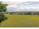 Scenic view of a large backyard with rolling hills and distant residences at 46531 Sundance Trl, Parker, CO 80138