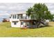 Exterior view with a walk-out basement and a balcony overlooking the grassy backyard at 46531 Sundance Trl, Parker, CO 80138