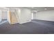 Finished basement featuring neutral carpet, white walls, staircase, and convenient access to other areas at 46531 Sundance Trl, Parker, CO 80138