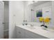 Bright bathroom featuring a white vanity with a sink and a large mirror, exuding cleanliness and functionality at 46531 Sundance Trl, Parker, CO 80138