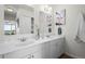 Bathroom featuring a dual sink vanity with white cabinets, marble countertop, and elegant fixtures, offering a touch of luxury at 46531 Sundance Trl, Parker, CO 80138