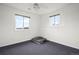 Bedroom featuring a ceiling fan, and two windows providing natural light and garden views at 46531 Sundance Trl, Parker, CO 80138