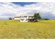 Exterior view of the house featuring a walk-out basement and open grassy area at 46531 Sundance Trl, Parker, CO 80138