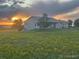 Lovely exterior of home at sunset with verdant lawn and lots of room to roam at 46531 Sundance Trl, Parker, CO 80138