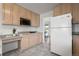 Well-lit kitchen with wood cabinets and views into the living area at 46531 Sundance Trl, Parker, CO 80138