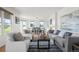 Inviting living room boasts ample seating and natural light, seamlessly connecting to a dining area with picturesque outdoor views at 46531 Sundance Trl, Parker, CO 80138