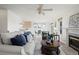 Spacious living room with a fireplace and adjacent dining area, ideal for Gathering gatherings at 46531 Sundance Trl, Parker, CO 80138