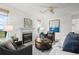 Cozy living room with a fireplace, ceiling fan, and scenic view from the window at 46531 Sundance Trl, Parker, CO 80138