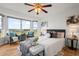 Serene main bedroom with a large bay window offering beautiful views, enhanced by hardwood floors and elegant furnishings at 46531 Sundance Trl, Parker, CO 80138