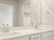 Bathroom vanity with double sinks, modern chrome faucets and large mirror reflecting the room at 22340 E 8Th Ave, Aurora, CO 80018