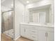 Bathroom features double sinks, large mirror, wood floor and a glass enclosed tiled shower at 22340 E 8Th Ave, Aurora, CO 80018
