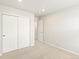 Well-lit bedroom features a closet with sliding doors and an open doorway to the hallway at 22340 E 8Th Ave, Aurora, CO 80018