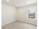 Bright bedroom with large window and neutral carpet flooring and ceiling lights at 22340 E 8Th Ave, Aurora, CO 80018